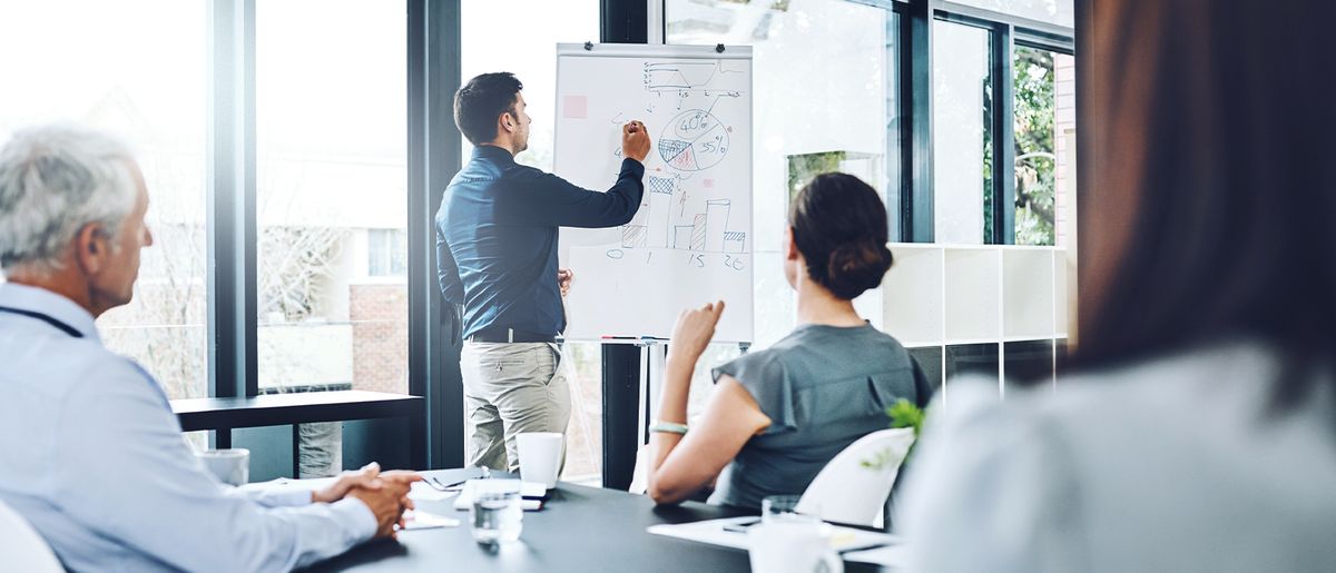 a team of four people working for a large enterprise in a workshop