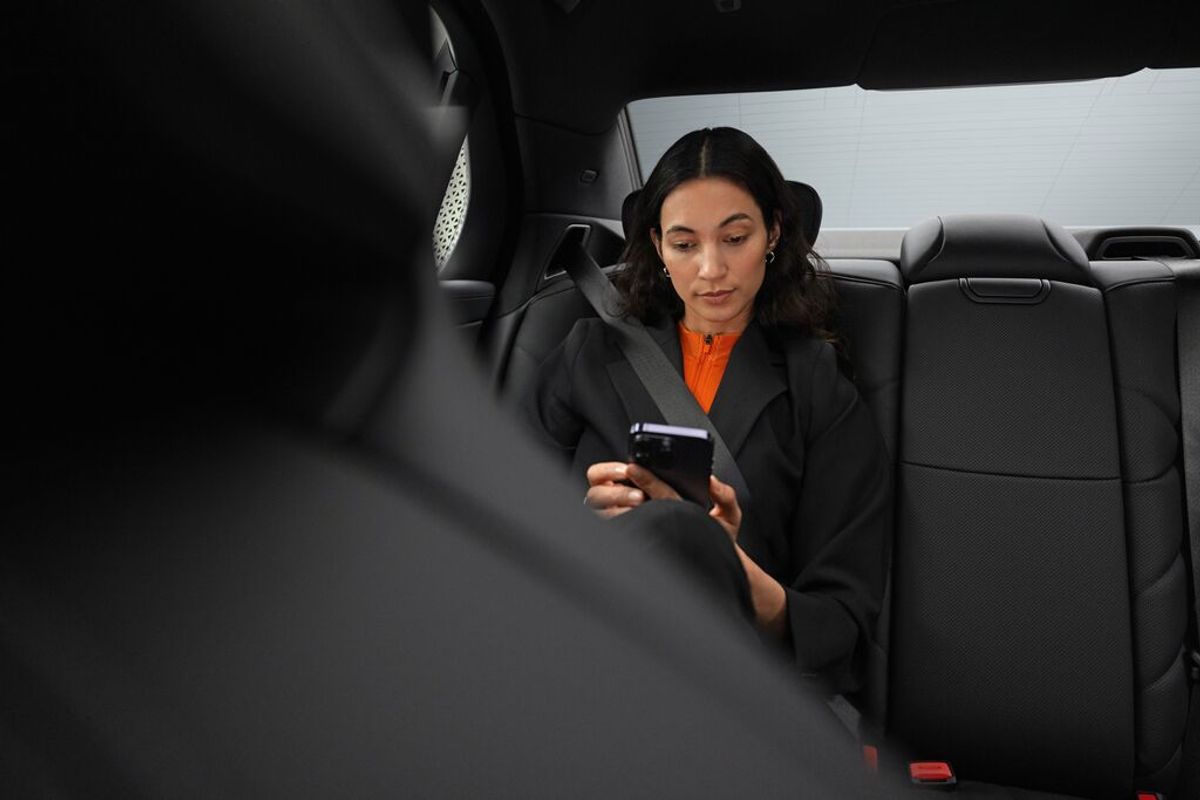 Business woman sitting in the back of a car