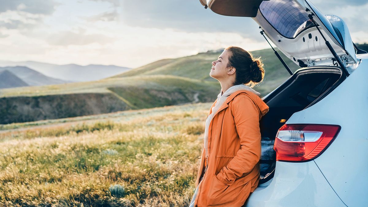 Woman standing next to the car
