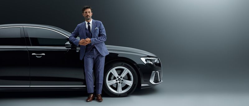 Business owner holding EIN documentation with company vehicle in background.