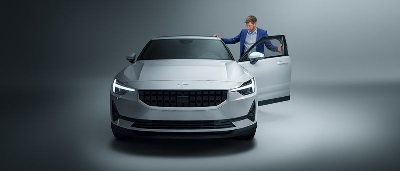 a business man entering a car